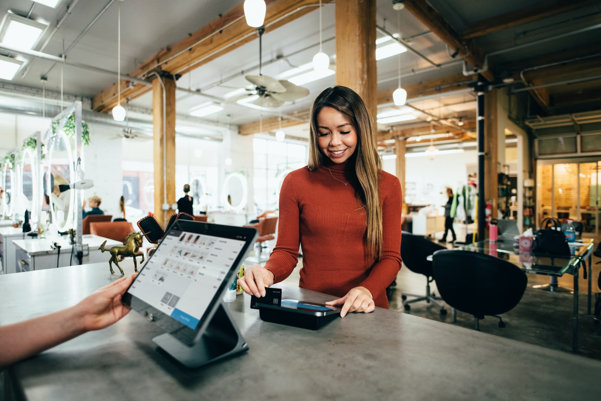 woman using credit card at business