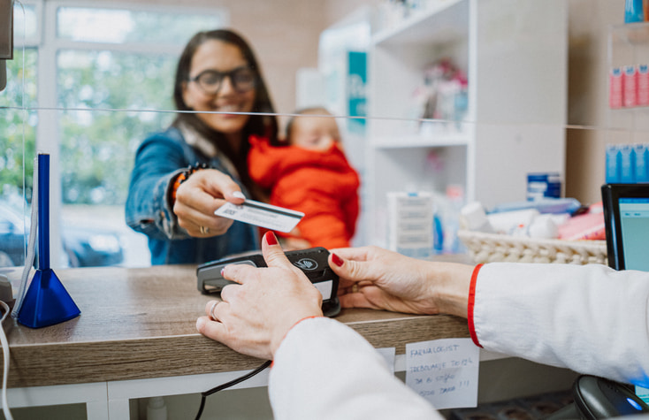 woman making payment at pharmacy